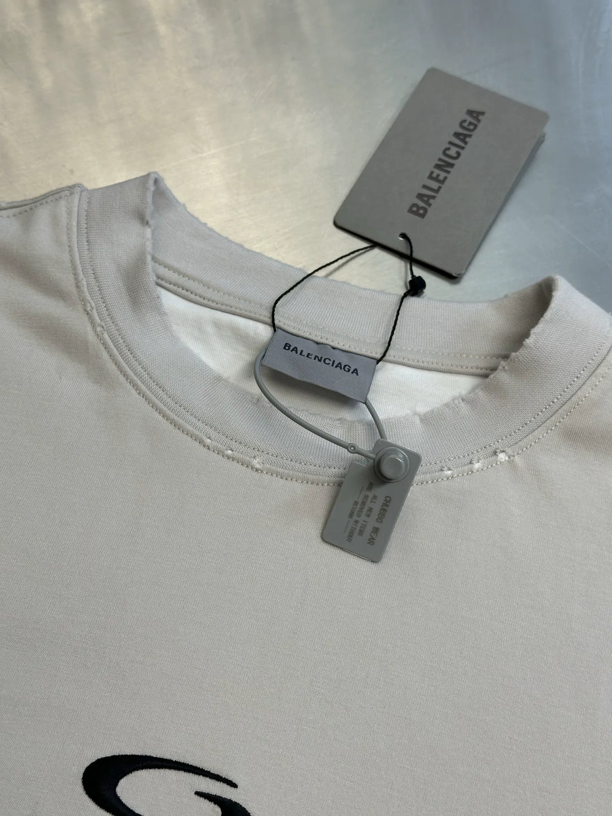 White Balenciaga T-shirt neckline with hang tags and stitched crew collar.