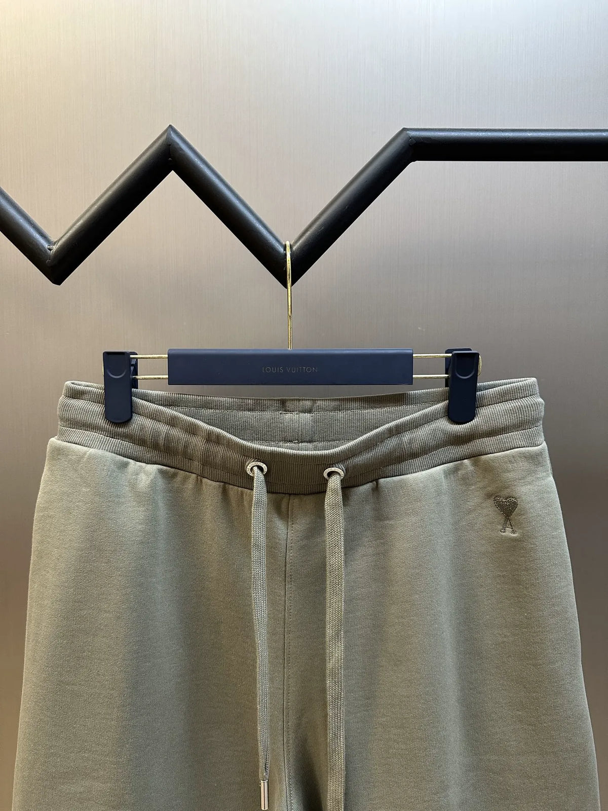 Light taupe drawstring shorts, front view with logo on left leg