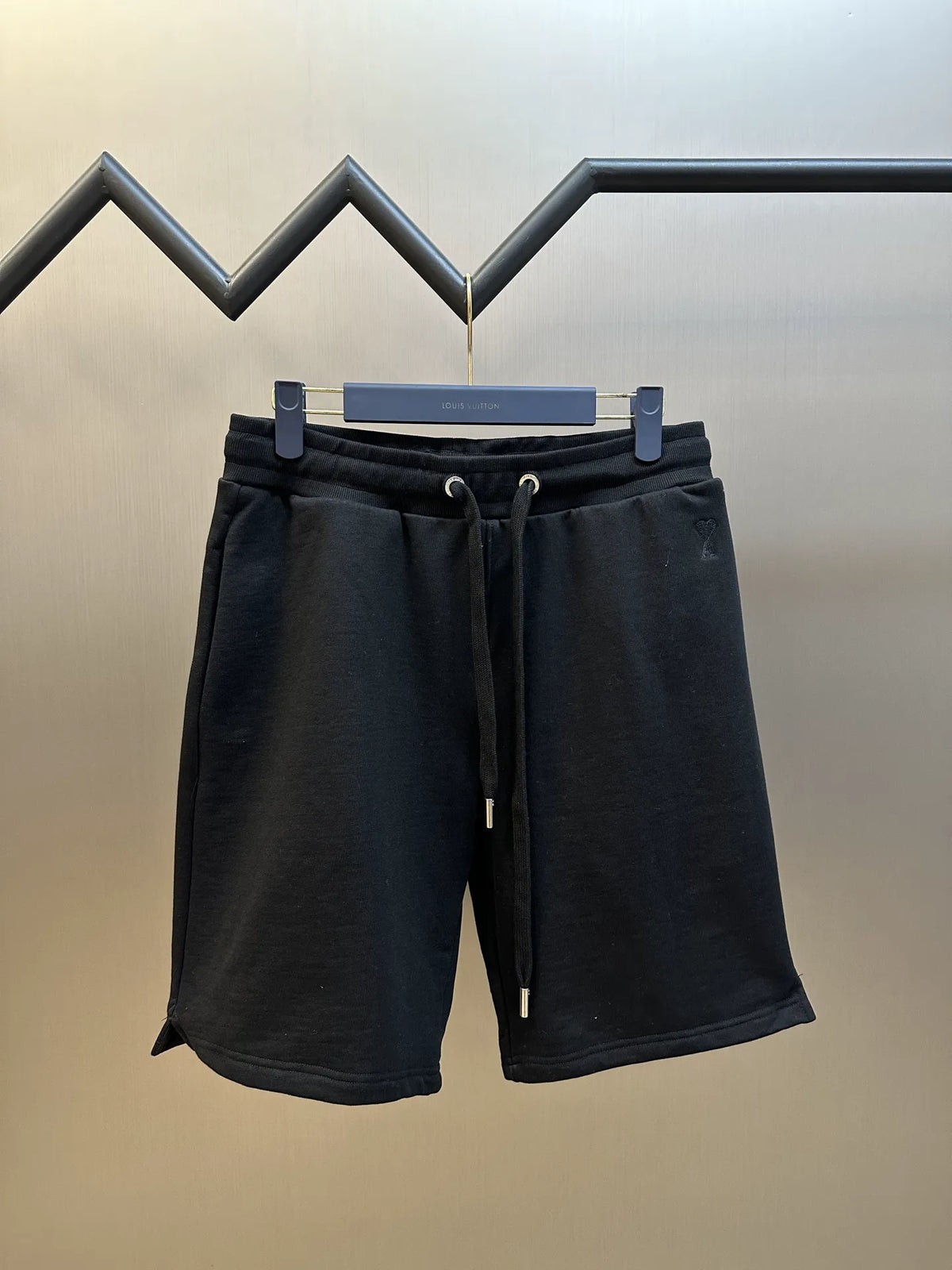 Dark drawstring shorts with elastic waistband and two side pockets