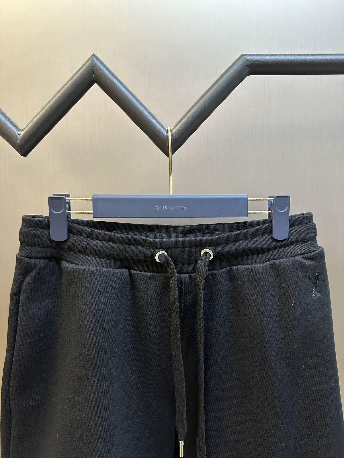 Dark drawstring shorts front view with elastic waist and adjustable cords