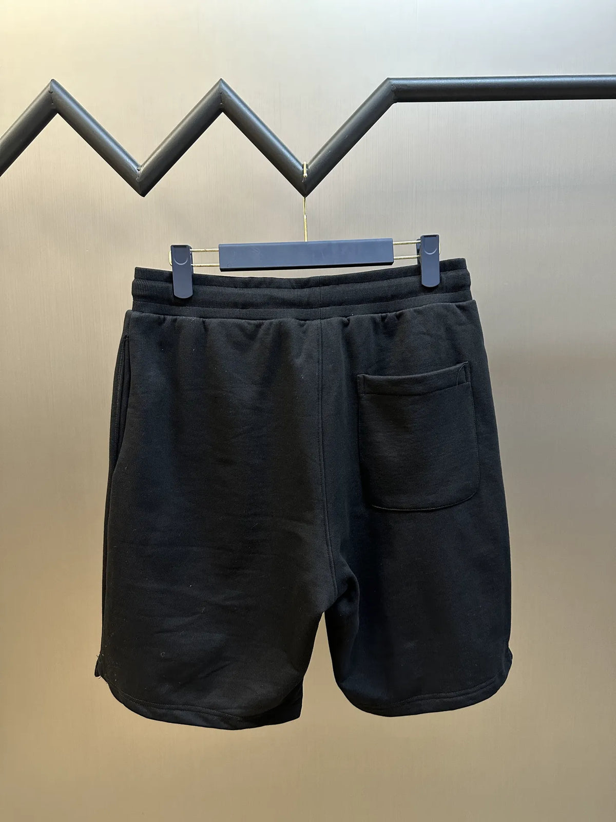 Dark drawstring shorts with front pocket and relaxed leg silhouette