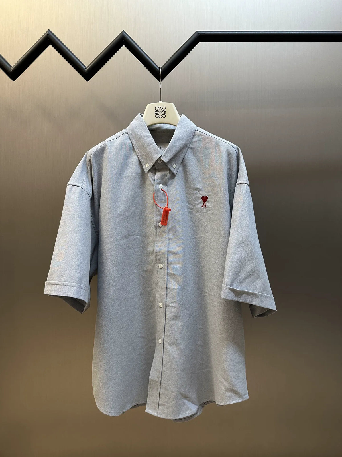 Light gray short-sleeve button-up shirt with pointed collar and front buttons