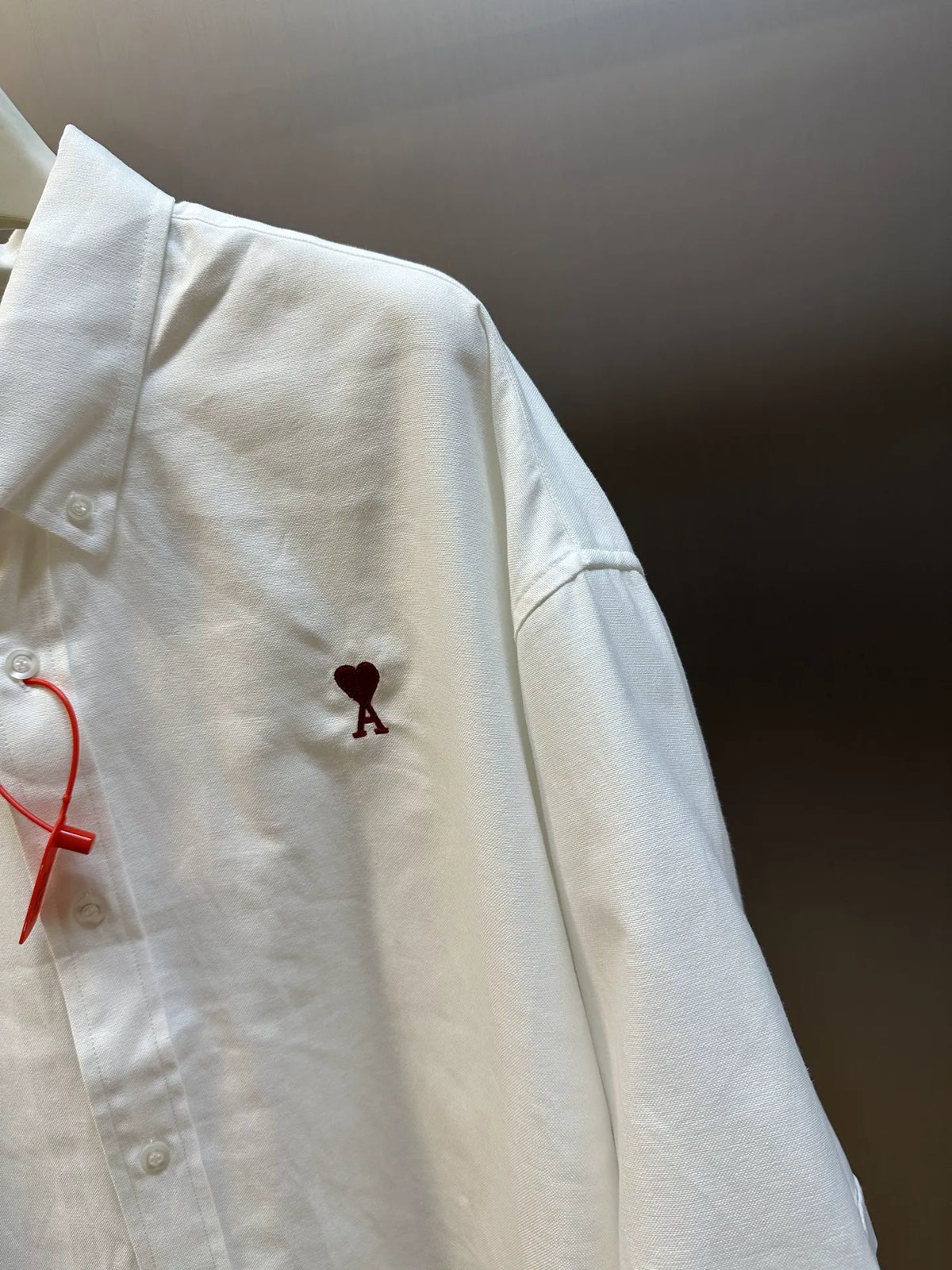 White short-sleeve button-up shirt with side logo embroidery