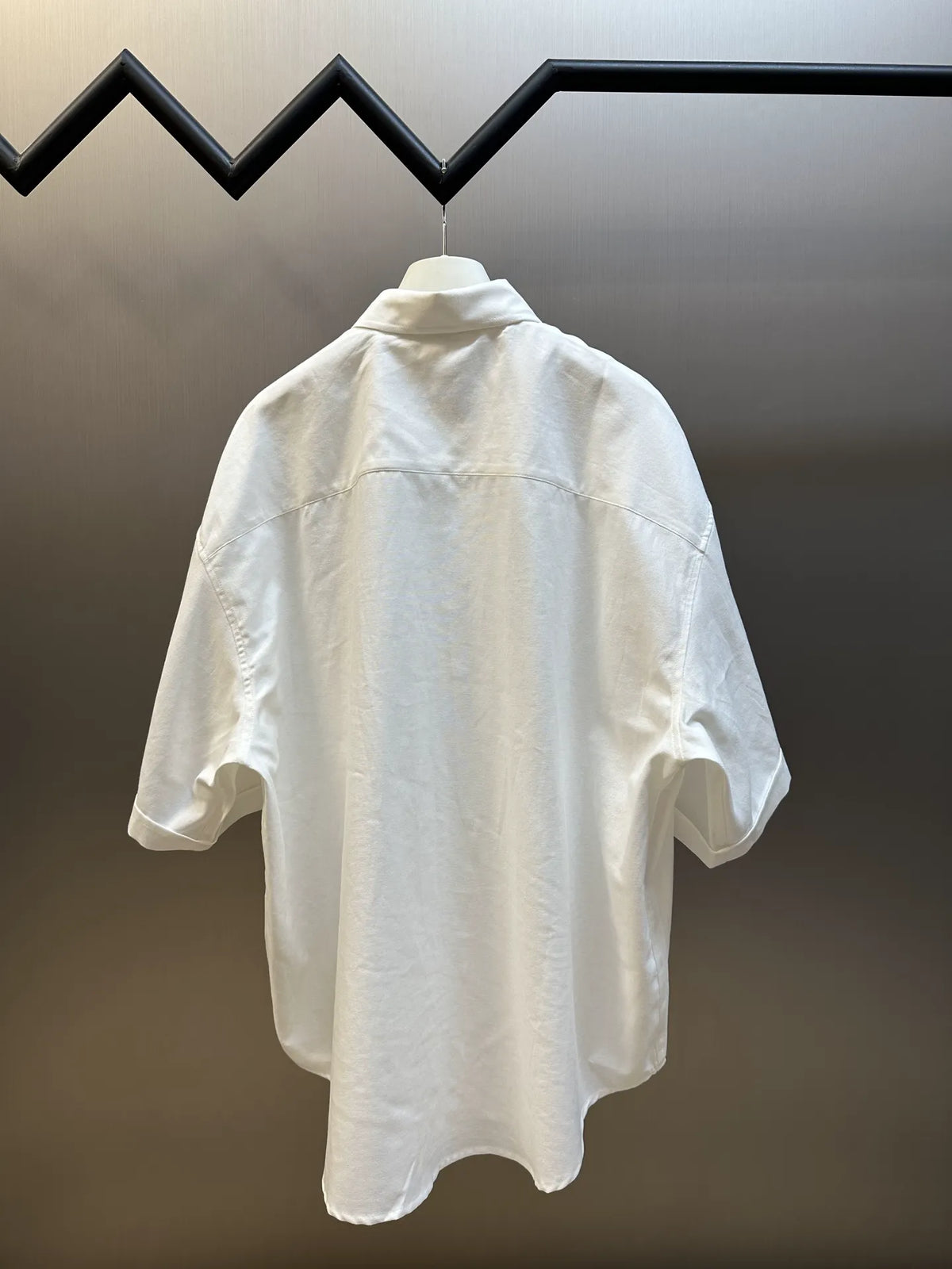 White short-sleeve button-up shirt back view with raised collar