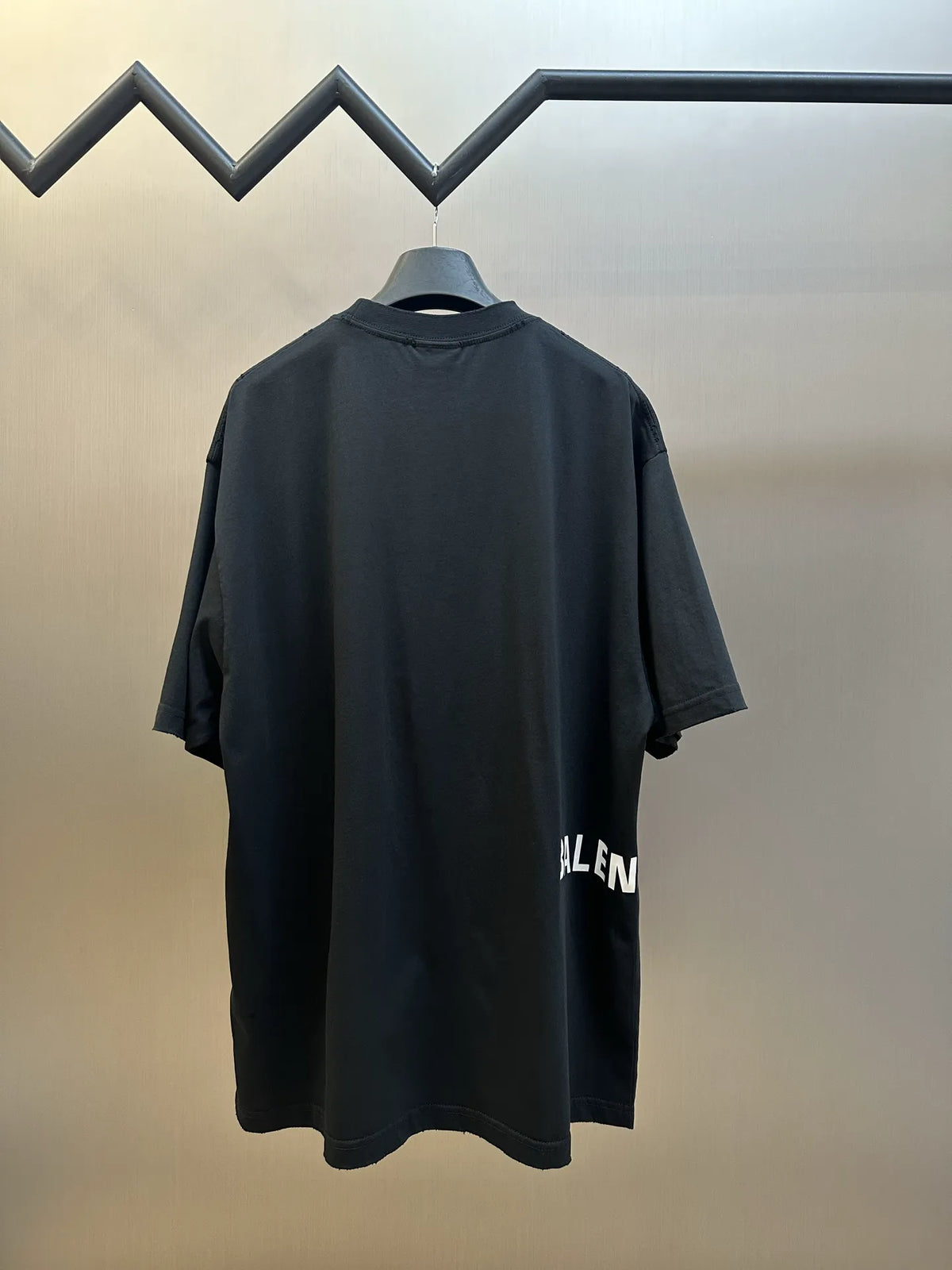 Black crewneck T-shirt with rear drape and partial “BALENCIAGA” logo