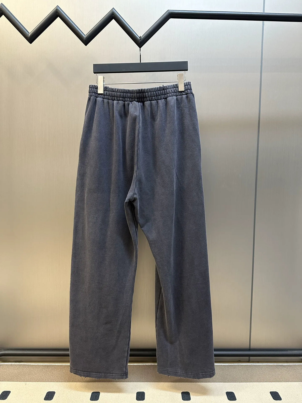 Dark blue wide-leg pants with elastic waistband and clean, unbranded front