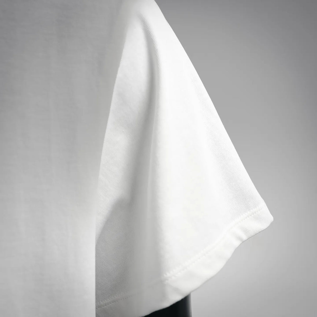 White T-shirt sleeve with folded cuff and side hem stitching