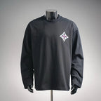 Black long-sleeve turtleneck top with multicolor diamond logo on left chest