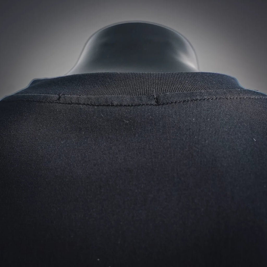 Back collar view of black long-sleeve turtleneck top with seam detail