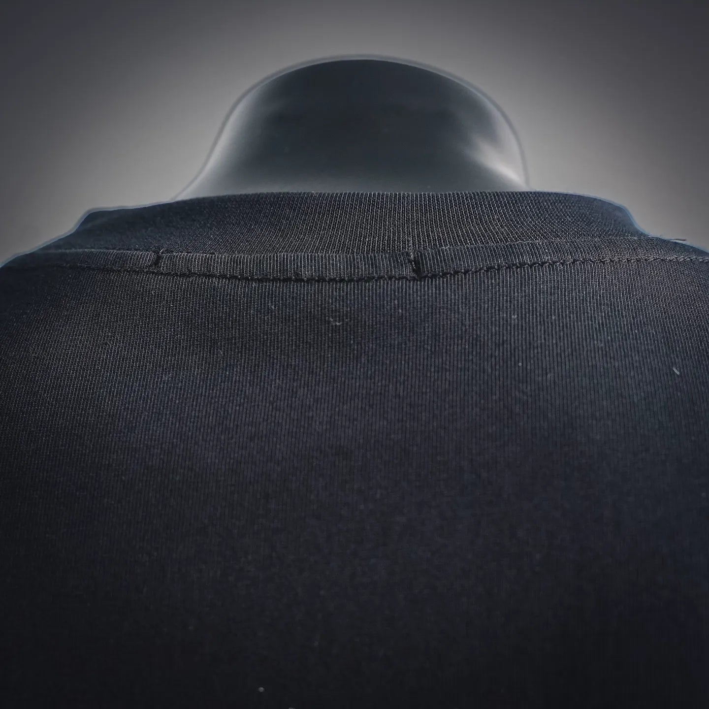Back collar view of black long-sleeve turtleneck top with seam detail