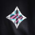 Diamond logo patch on the chest of a black long-sleeve turtleneck top
