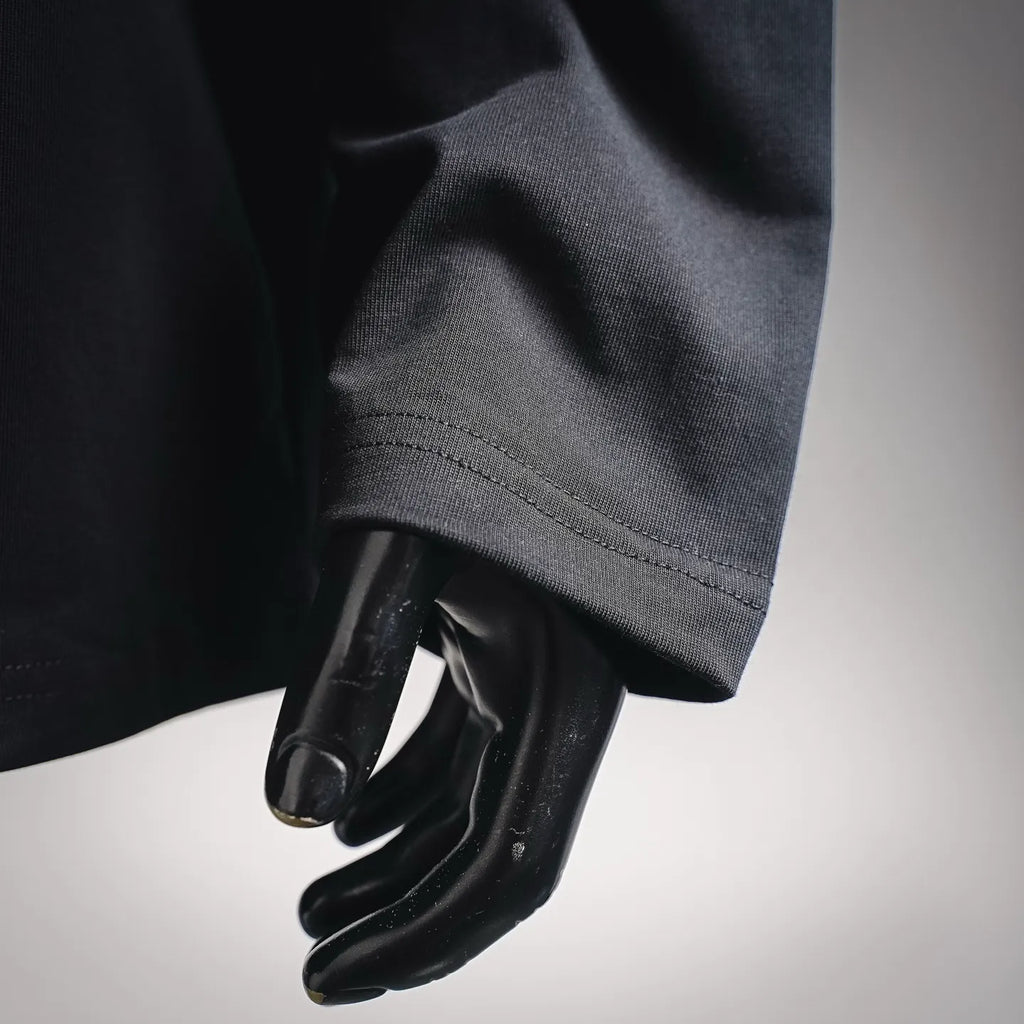 Black long-sleeve top sleeve and cuff detail on a mannequin