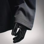 Black long-sleeve top sleeve and cuff detail on a mannequin