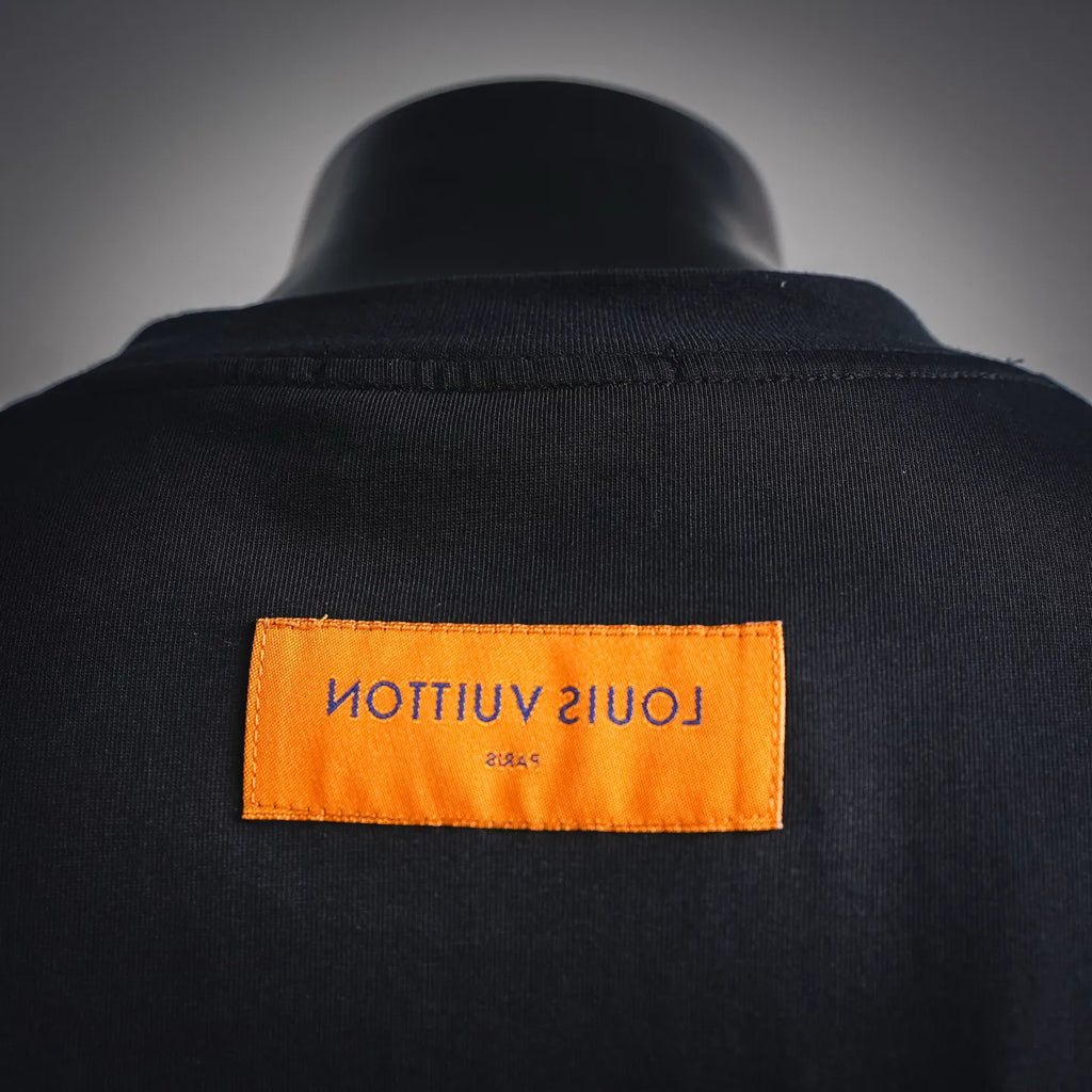 Louis Vuitton interior neck label, orange patch on black mock neck collar
