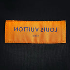 Louis Vuitton interior neck label on black collar, orange rectangular patch
