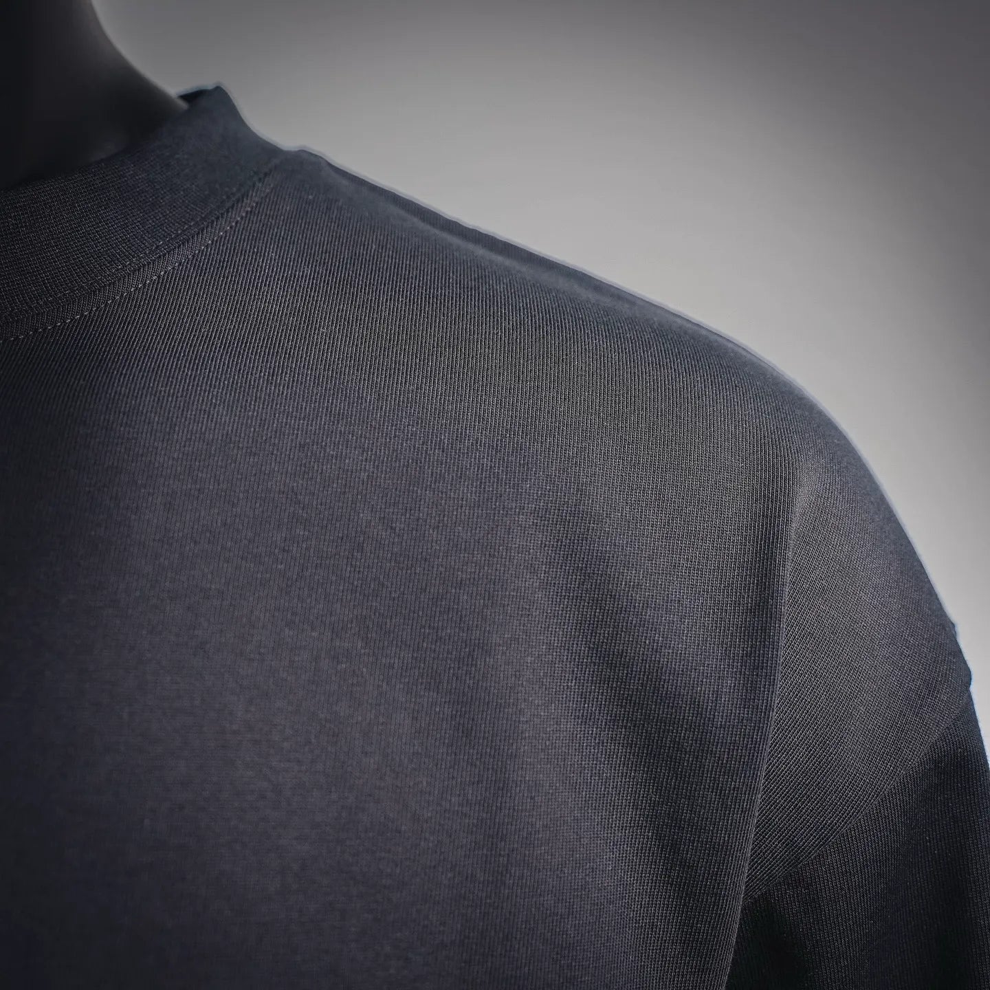 Louis Vuitton long-sleeve mock neck shirt, black fabric texture, side view