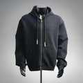 Black zip-up hoodie with hood, front pockets, gold zipper, pearl drawstring pulls