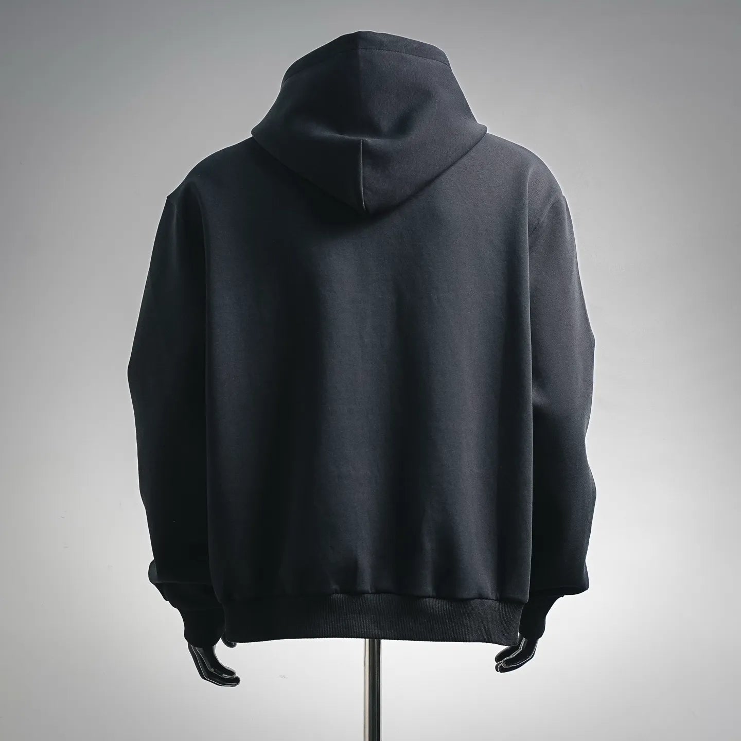 Black zip-up hoodie with hood, plain back, ribbed hem and cuffs