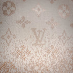 Close-up of cream knit fabric with scattered LV monogram motifs.