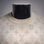 Ribbed crew neck on beige sweater with repeating LV monogram pattern.