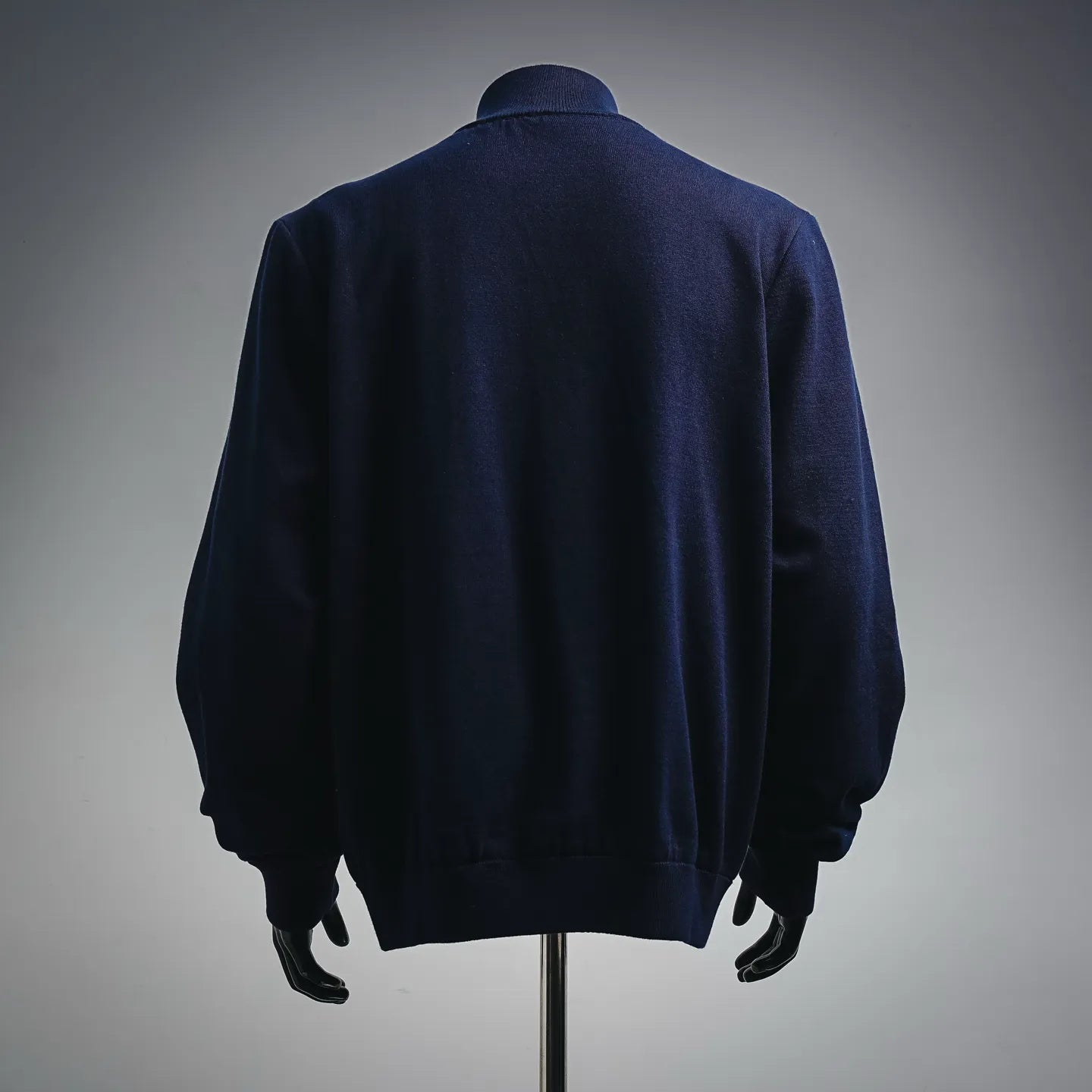 Navy LV zip-up coat, back view with ribbed hem and full sleeves