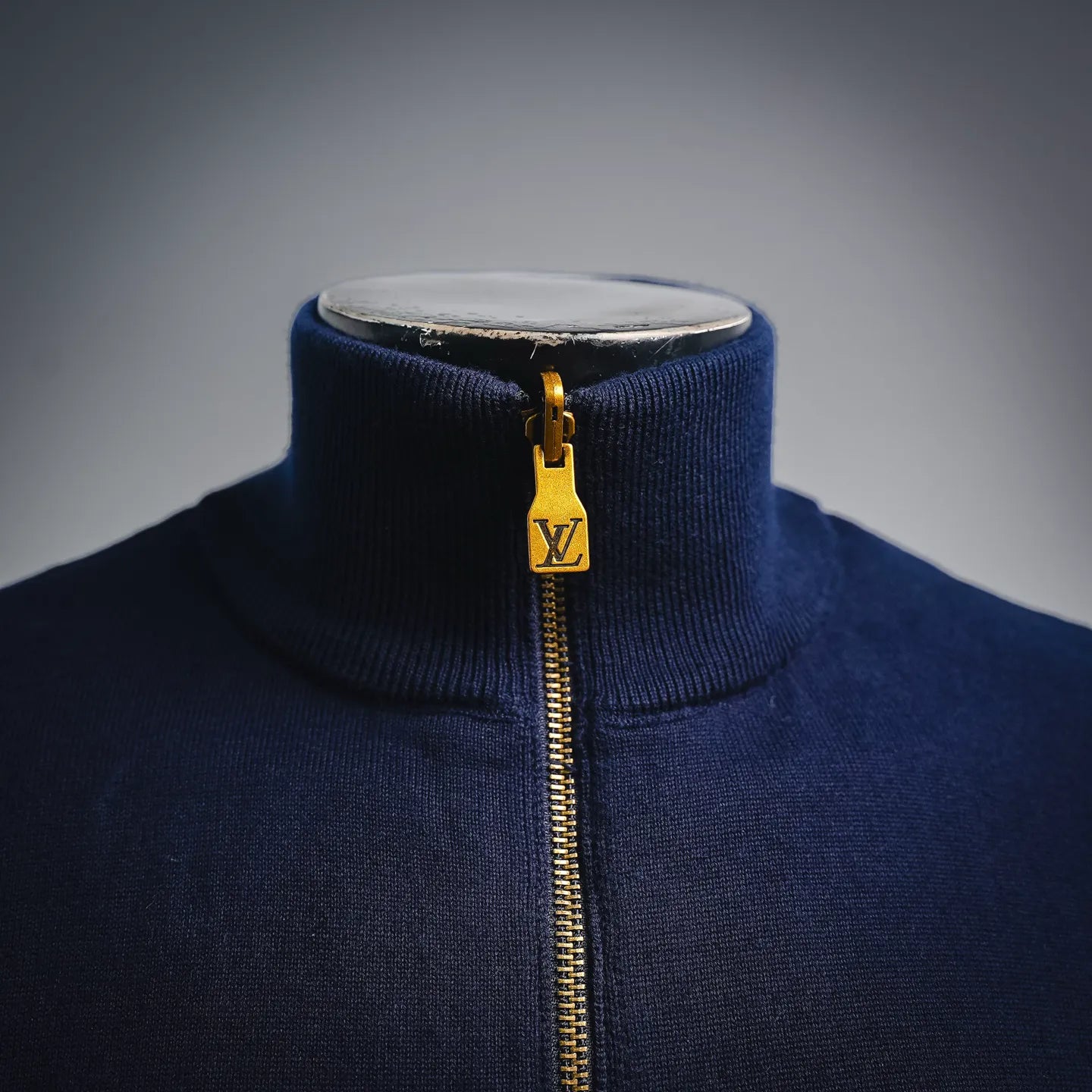 Navy LV zip-up coat neckline with ribbed collar and gold zipper pull