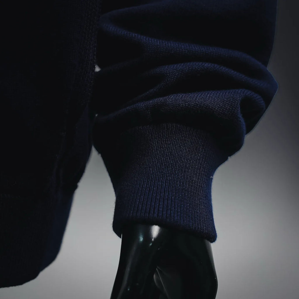 Navy ribbed coat sleeve cuff on an LV zip-up coat, close-up detail