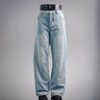 Light blue denim jeans with straight legs and button-fly closure