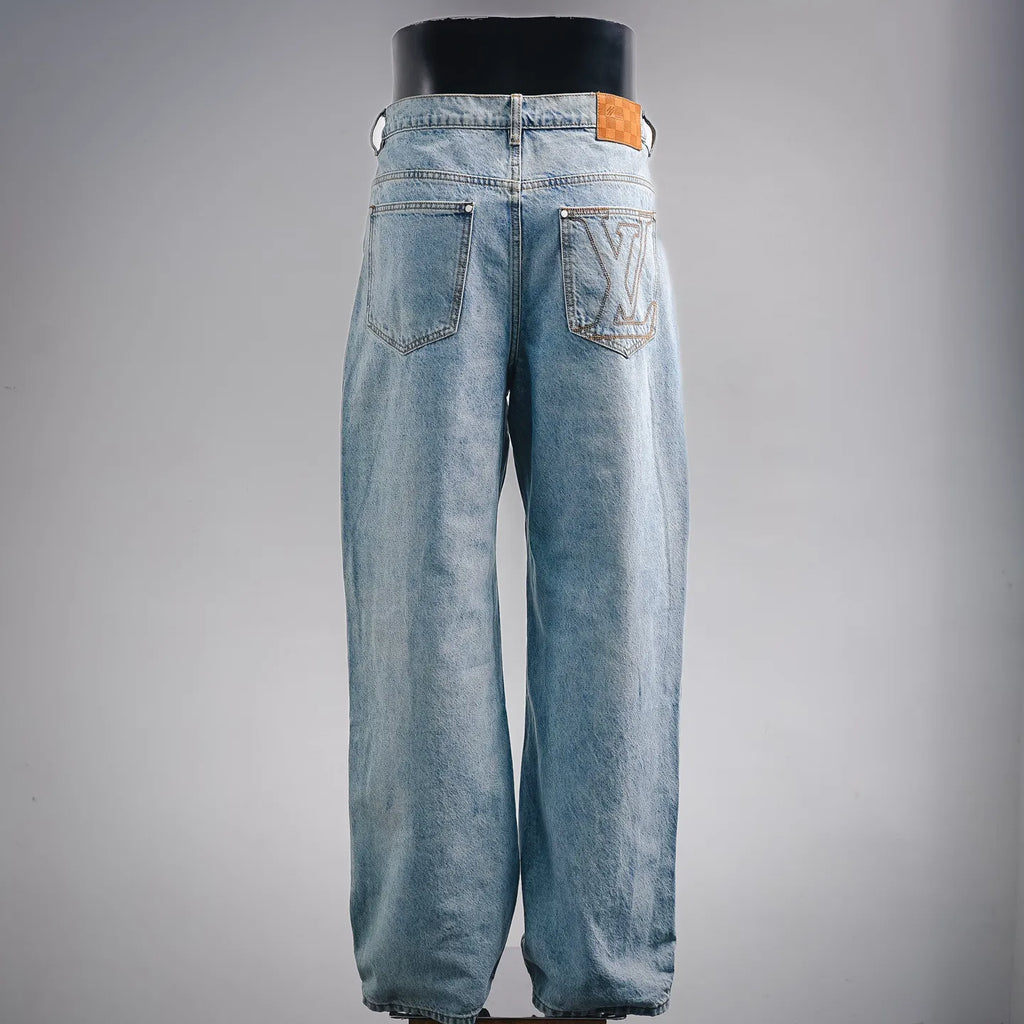 Light blue denim pants, back view with two patch pockets and button closure