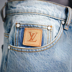 Light blue denim front waistband with tan LV leather patch and gold button rivets