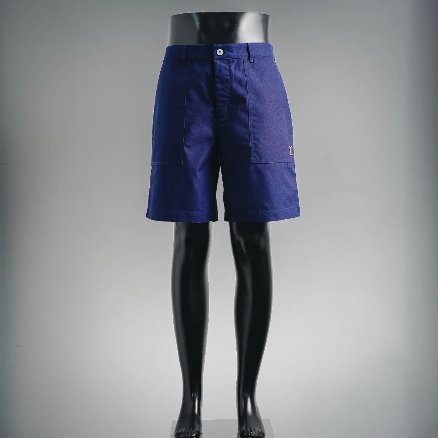 Blue Louis Vuitton shorts-style pants on mannequin, button closure and belt loops