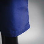 Blue shorts-style pants hem with fabric drape detail