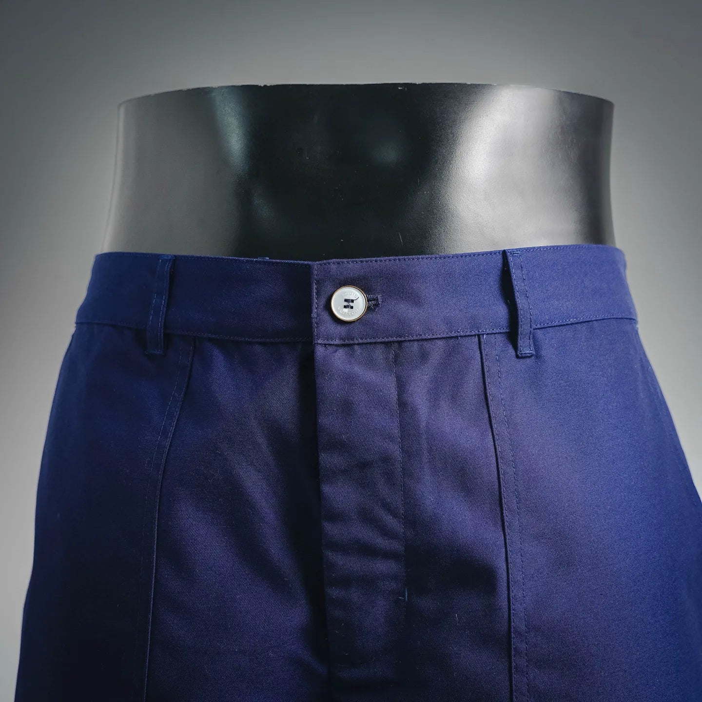 Blue shorts-style pants front with button waistband and belt loops