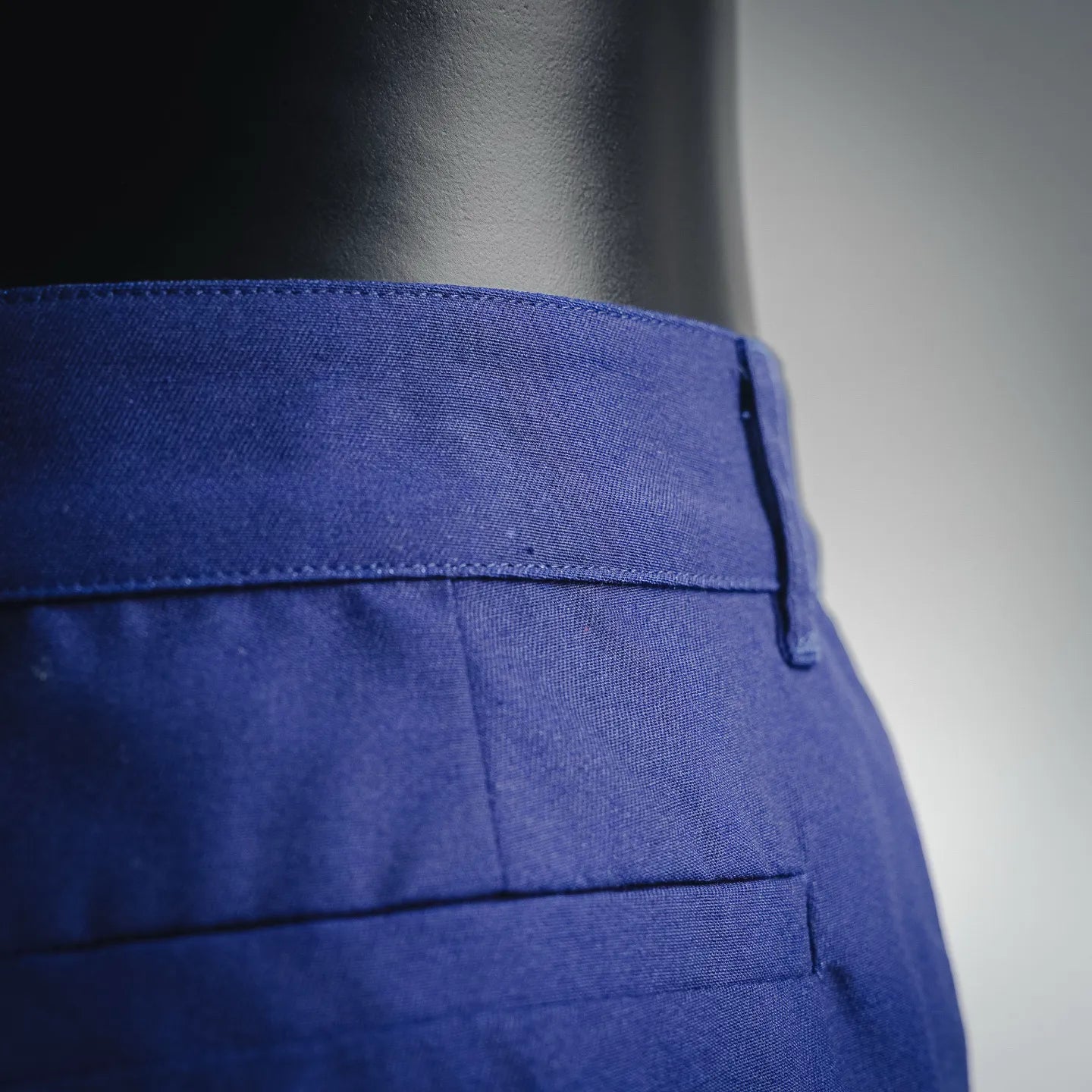 Blue shorts-style pants back panel with crease and stitched seams
