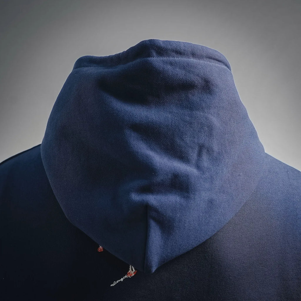 Navy hoodie hood with small embroidered detail near lower back