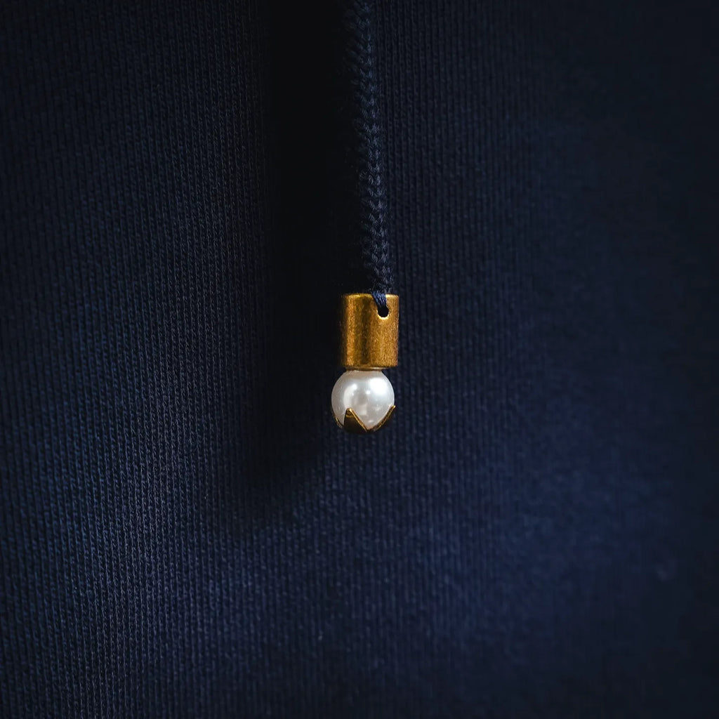 Hoodie drawstring with small metal charm at the end