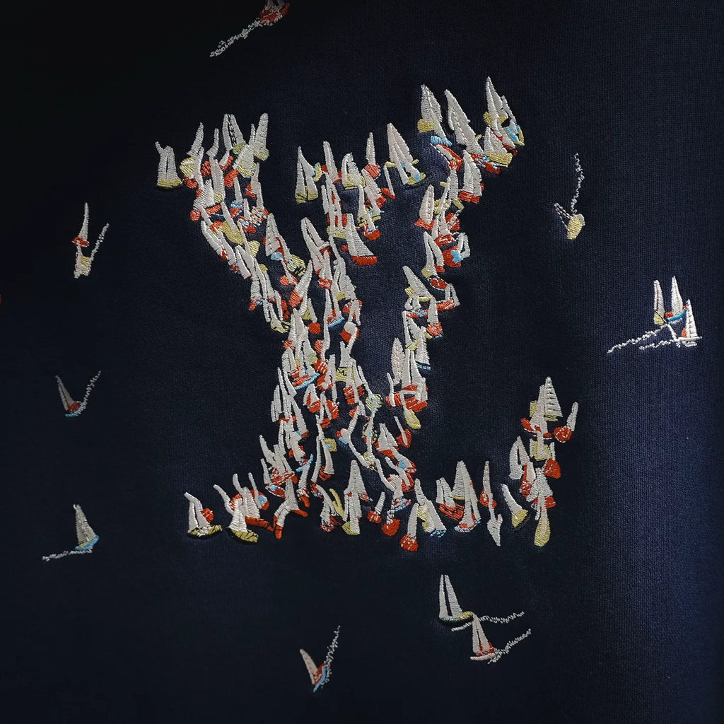 Navy hoodie back with dense embroidered bird graphic