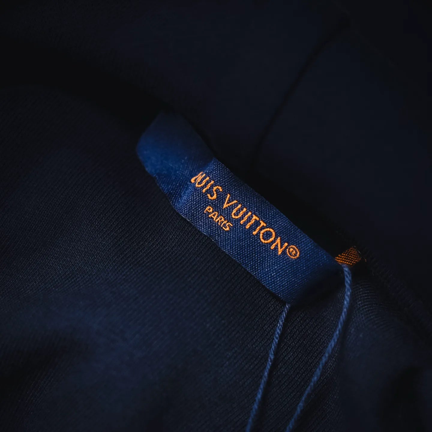 Navy hoodie inner neck label with LV logo and Paris text