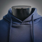Navy hoodie close-up at hood and neckline with drawstring openings