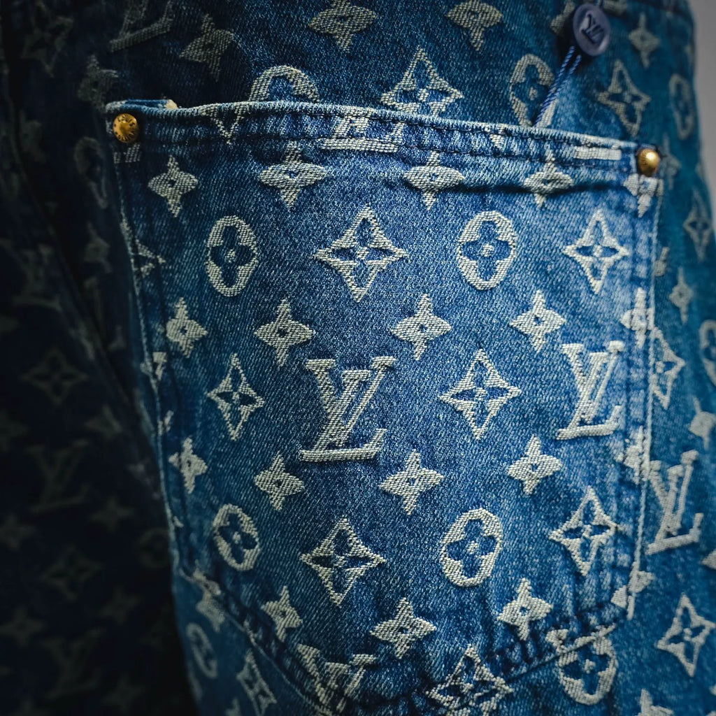 Blue denim shorts with scattered LV monogram print, close-up fabric texture