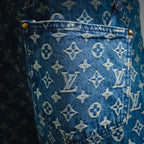Blue denim shorts with scattered LV monogram print, close-up fabric texture