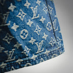 Blue denim shorts side hem with LV monogram pattern, close-up