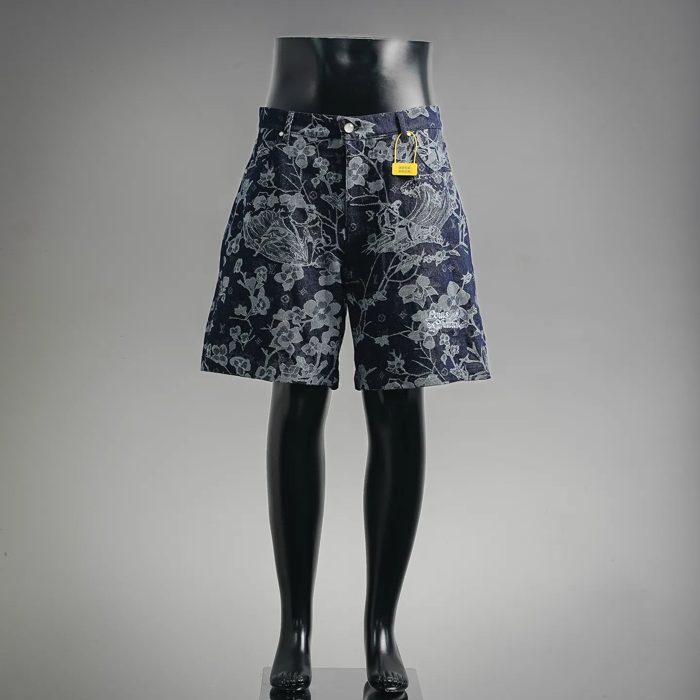Louis Vuitton pants in dark denim with light floral pattern, front view