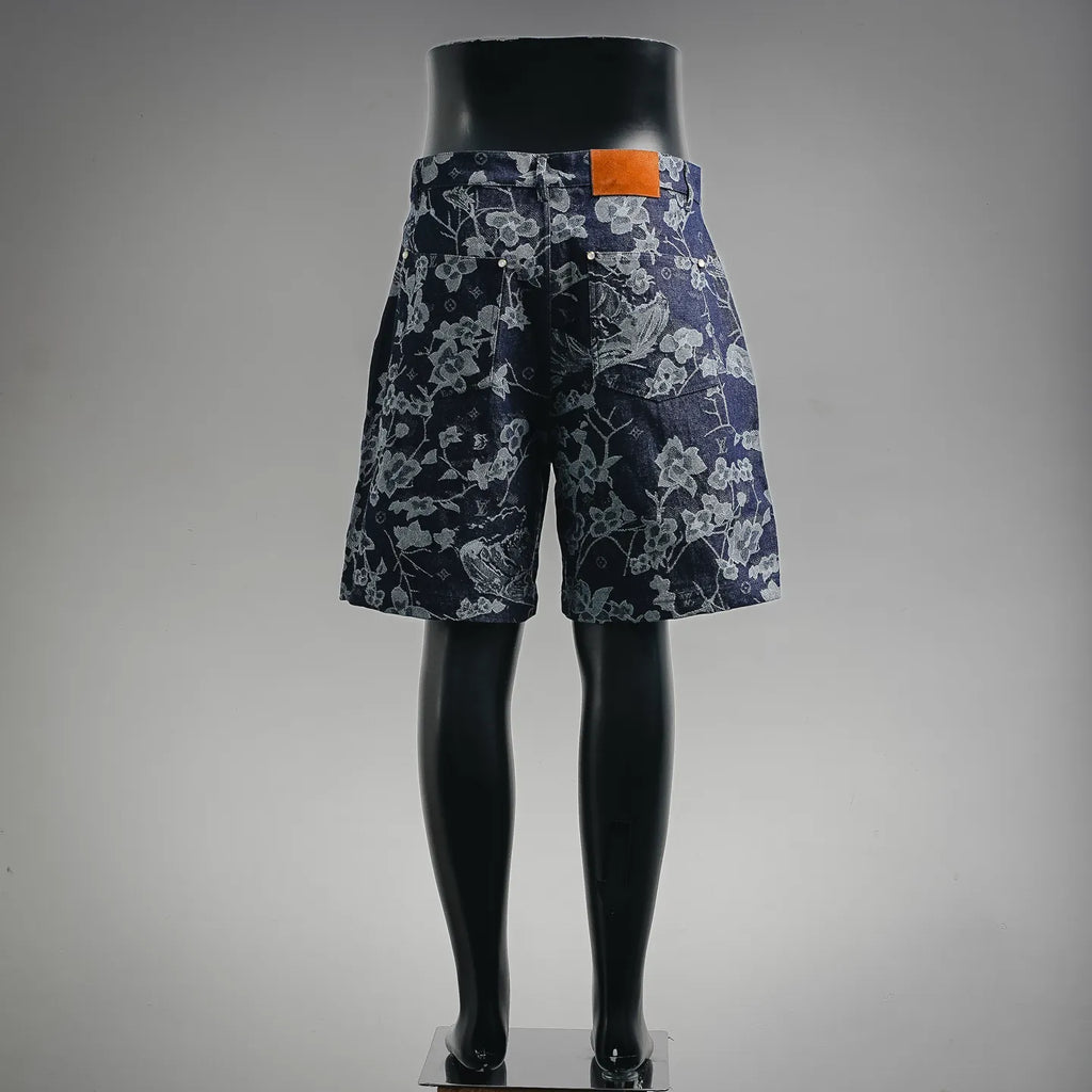 Louis Vuitton pants in dark denim with floral print and orange waistband tag, back view