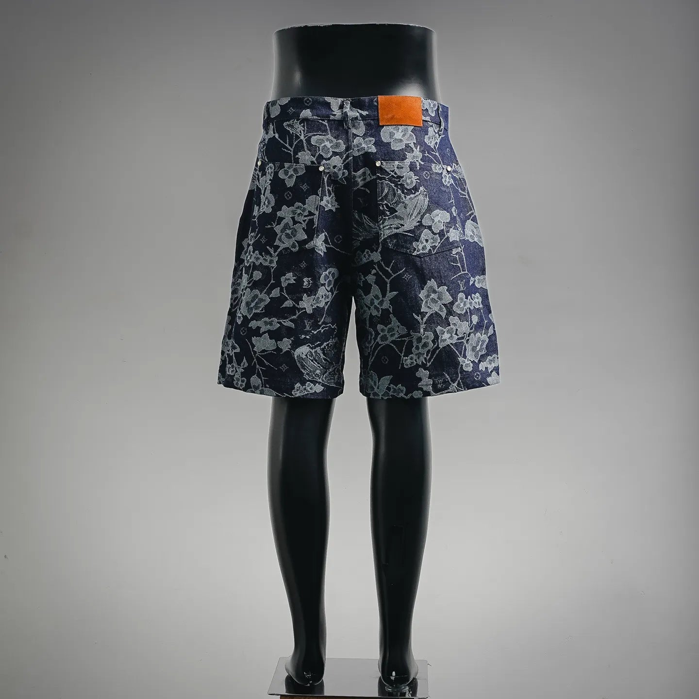 Louis Vuitton pants in dark denim with floral print and orange waistband tag, back view