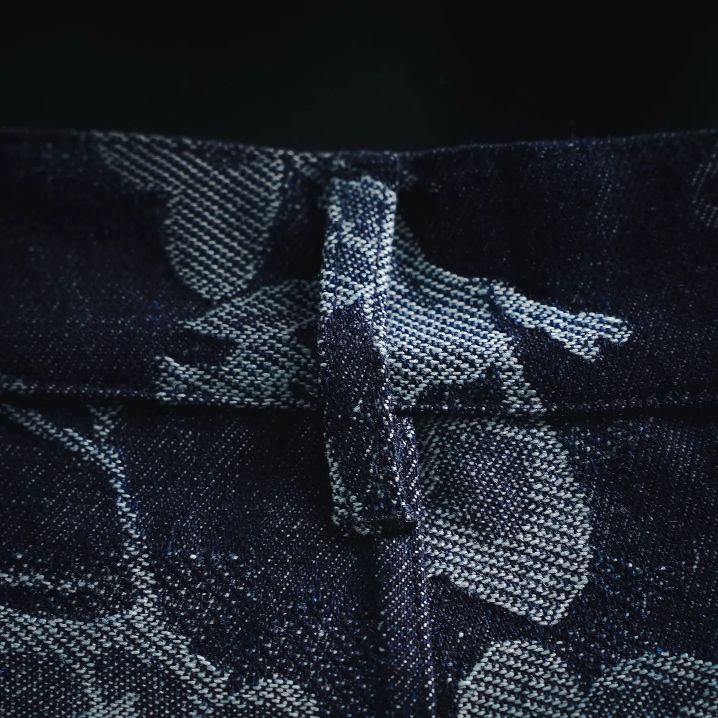 Front seam with button closure on patterned dark denim