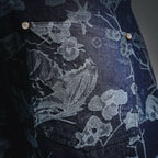 Dark denim pants with floral print and metal button rivets