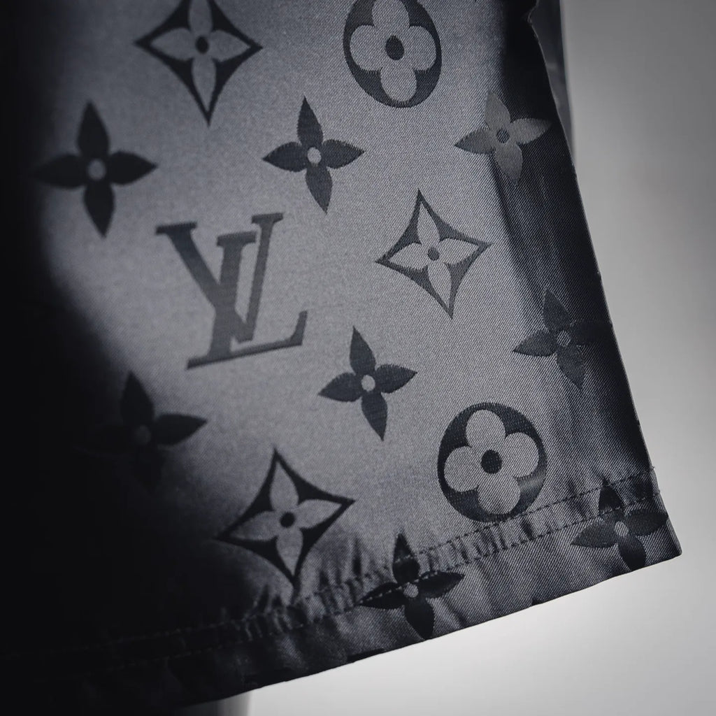 Louis Vuitton monogram shorts fabric close-up with dark pattern print
