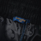 Louis Vuitton shorts size/care tag on black monogram fabric