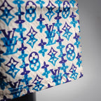 Close-up of blue, navy, and white monogram pattern fabric on shorts